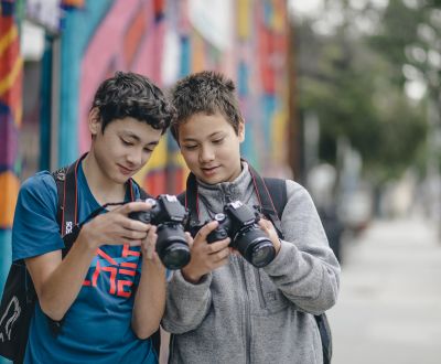 two students holding photography cameras at the School of Arts and Enterprise charter 6-12th grades