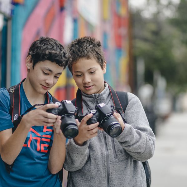 two students holding photography cameras at the School of Arts and Enterprise charter 6-12th grades