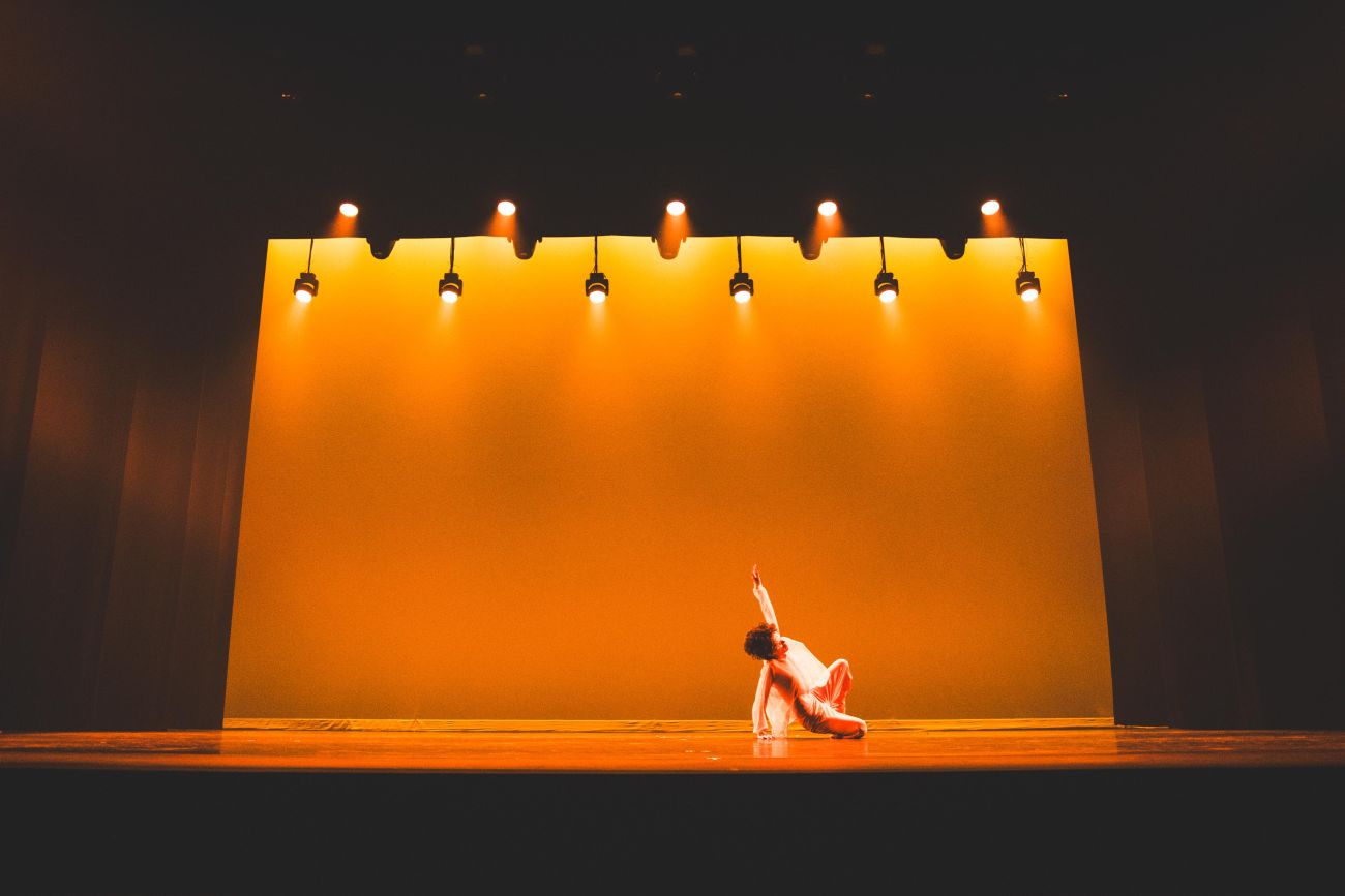 A solo dancer performs on stage