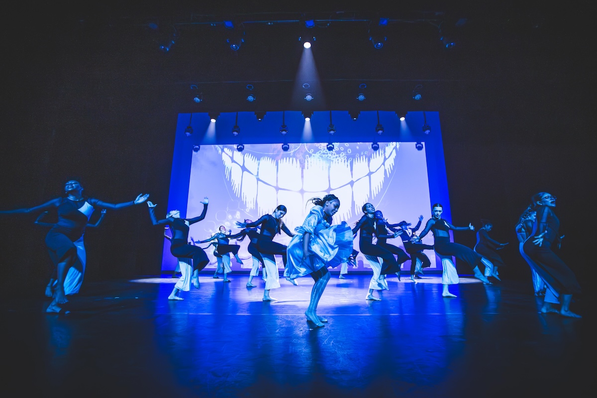 dance students at The School of Arts and Enterprise performing on stage in a blue light
